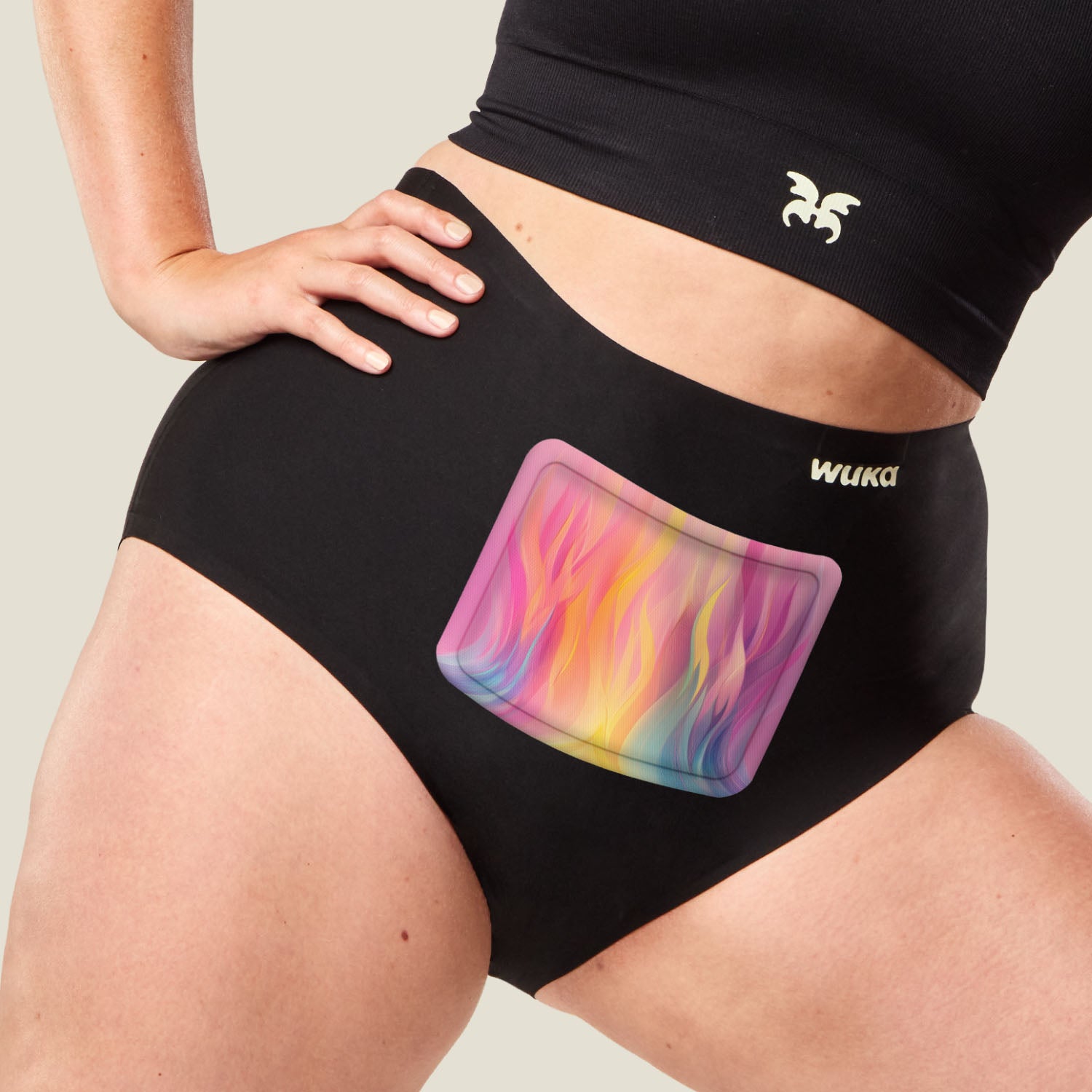 Close-up of WUKA Heat Patch applied to black period pants, highlighting targeted relief for menstrual cramps.