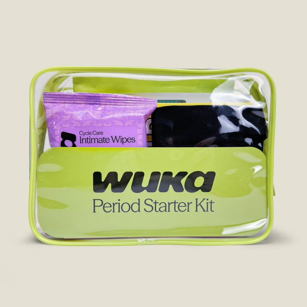 Front view of WUKA Period Starter Kit in a clear green zip pouch, showing included Cycle Care Intimate Wipes, pink Stretch™ period pants, and other essentials for first periods.