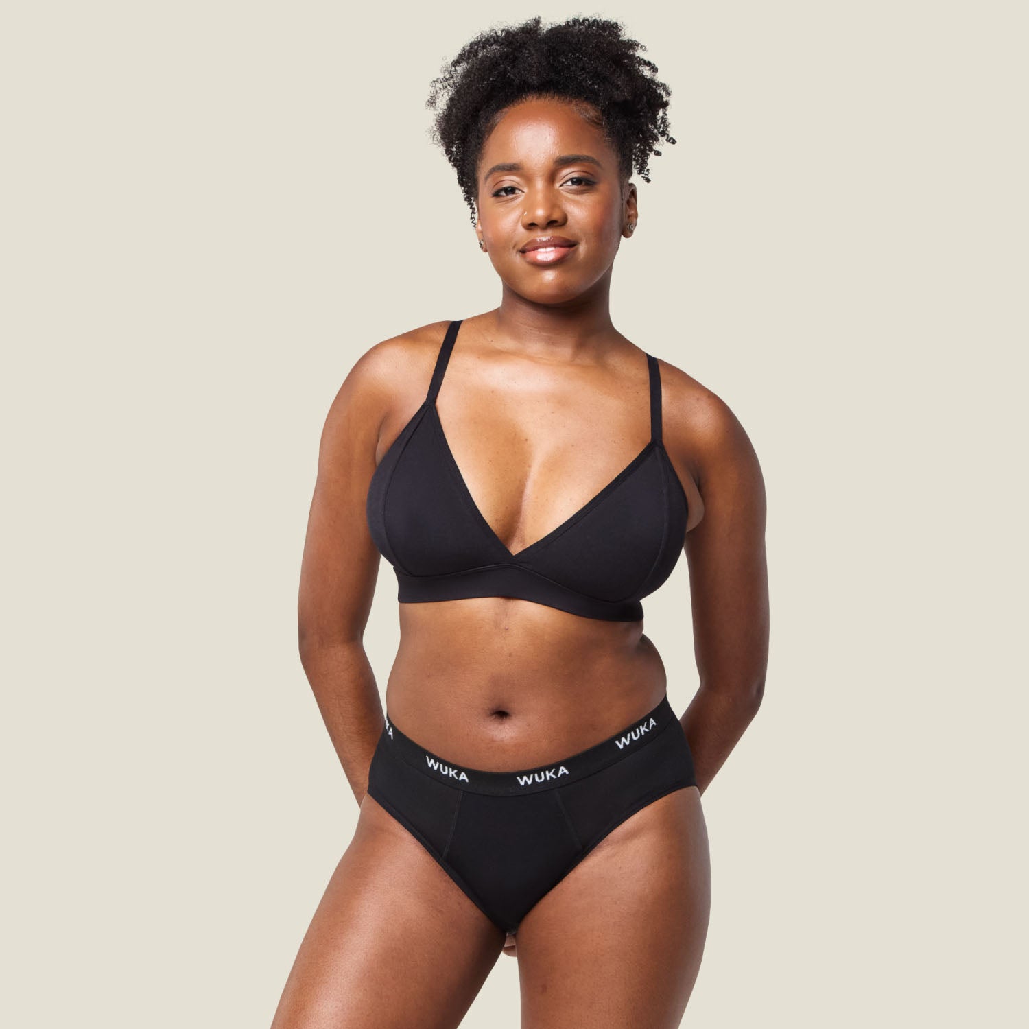 Model wearing WUKA Ultimate™ Midi Brief Super Heavy Flow period underwear in black, full body front view for comfortable and secure protection.