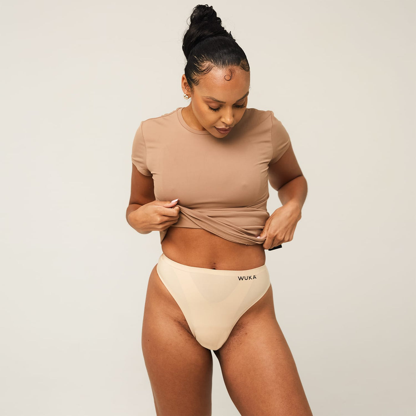 WUKA Stretch Thong Style Light to Medium Absorbency Light Nude Colour Three Quarter Front Size 1