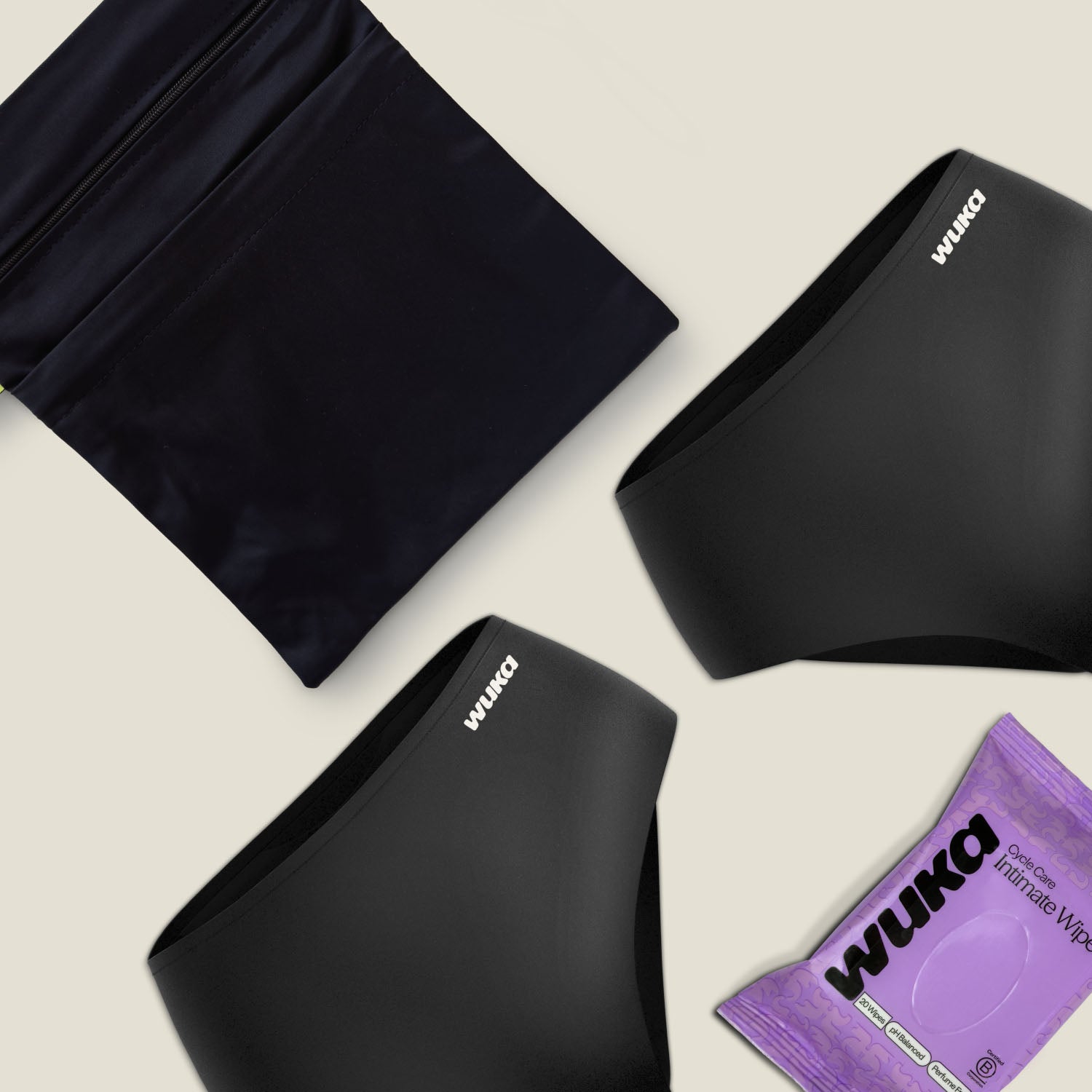 Close-up of WUKA Go Bag period care kit, highlighting product textures and clean minimalist design, including reusable period pants, a sleek 2-pocket changing bag, and intimate wipes