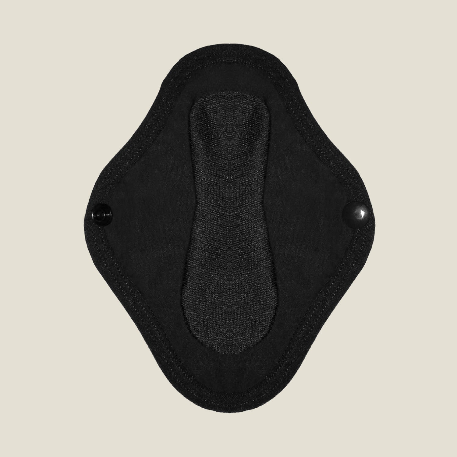 Close-up view of the absorbent inner layer of the WUKA reusable panty liner for light flow, featuring secure popper fastenings for a snug fit.