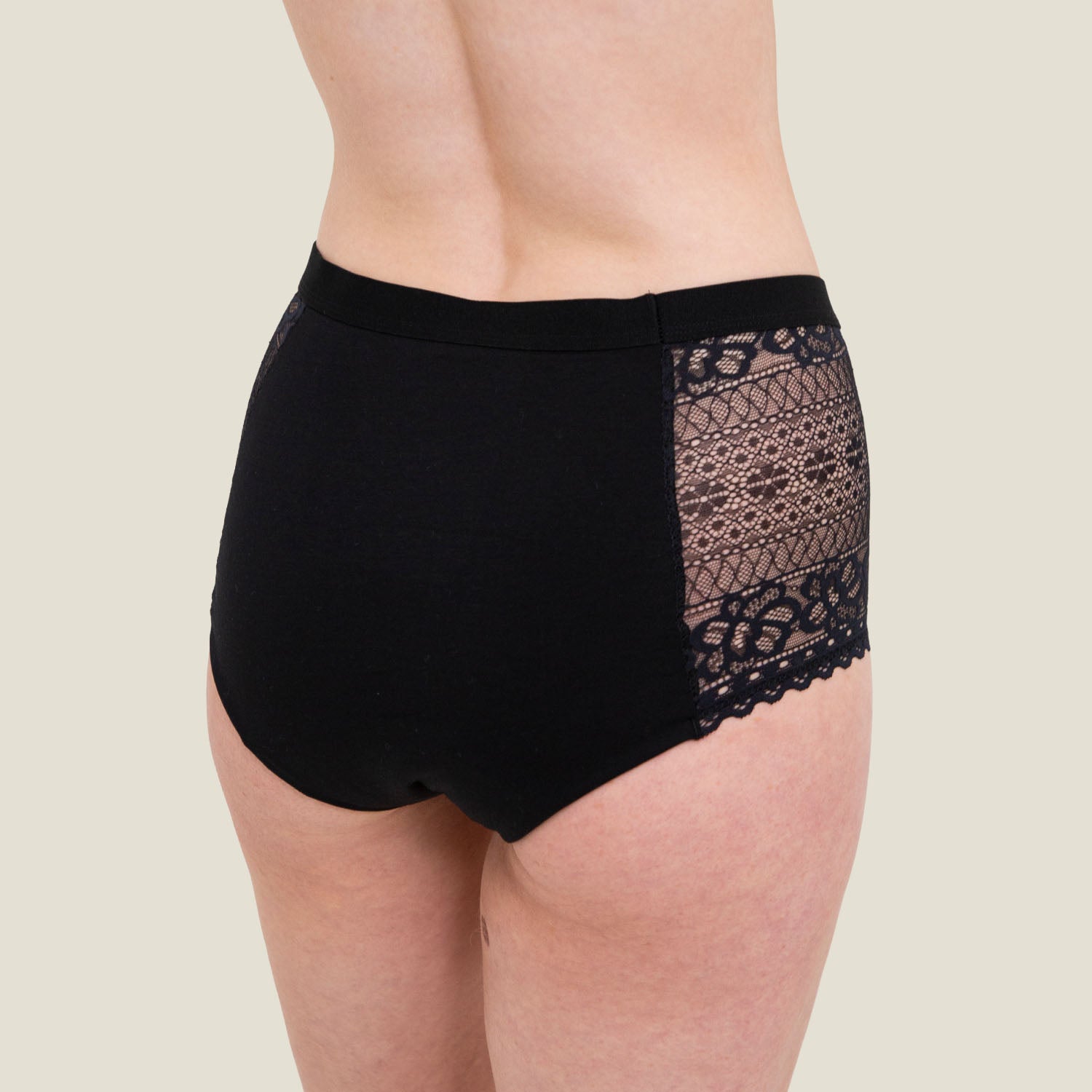 Side profile of WUKA Ultimate™ Lace High Waist Period Pants in black, featuring breathable lace inserts and a flattering high waist cut for heavy flow protection.