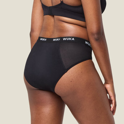 Back view of WUKA Ultimate™ Midi Brief Period Pants displaying full coverage fit and mesh side panels for postpartum comfort.