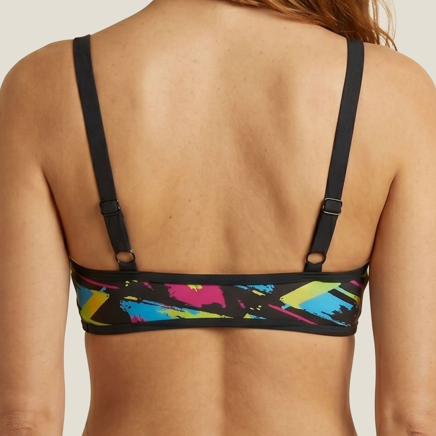 Back view of the WUKA Lunafly Competition Bikini top showing the racerback cut — period swim top