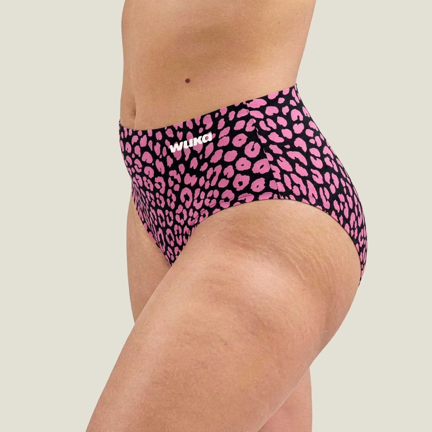 Close-up detail of WUKA Stretch™ pink leopard print fabric – bold pattern with branded waistband designed for heavy flow menstruation