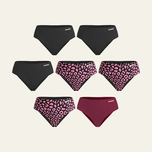 WUKA Adult Stretch™ 7-pack reusable period pants bundle. Seamless, multi-size leak-proof underwear for heavy flow in black, pink leopard, and burgundy. Your complete eco-friendly menstrual care cycle set providing all-day comfort and security.